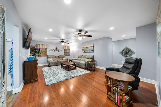 living room with ceiling fan and hardwood / wood-style flooring