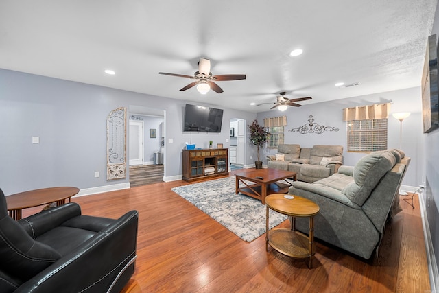 living room with hardwood / wood-style floors and ceiling fan