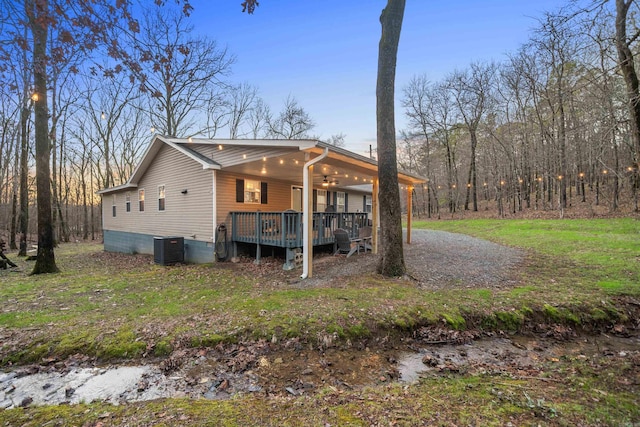 exterior space with a porch, ceiling fan, and central air condition unit