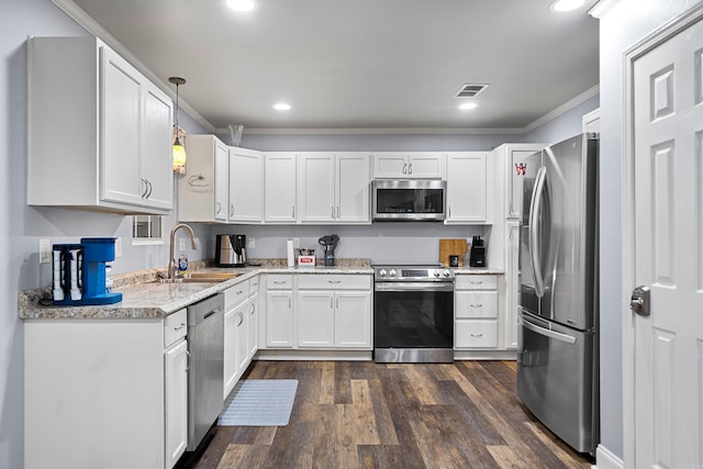 kitchen with stainless steel appliances, crown molding, sink, pendant lighting, and white cabinets