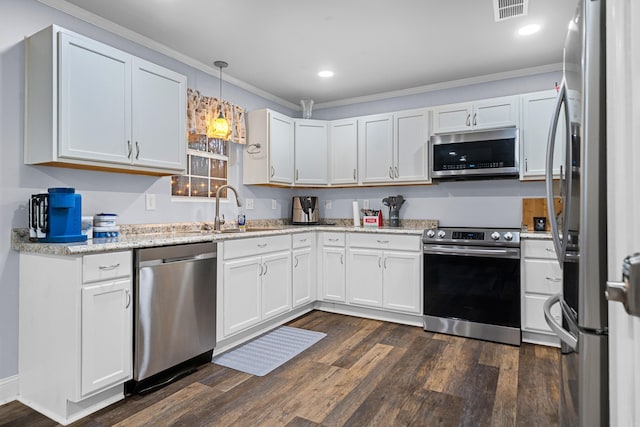 kitchen with white cabinetry, sink, hanging light fixtures, stainless steel appliances, and dark hardwood / wood-style flooring