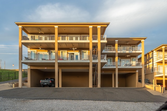 back of house with a balcony and central AC unit