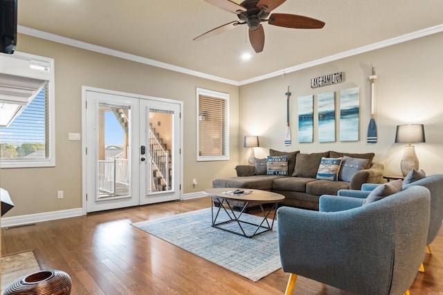 living room featuring ceiling fan, french doors, wood-type flooring, and ornamental molding