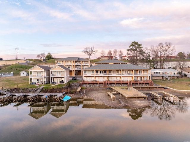 back house at dusk featuring a water view