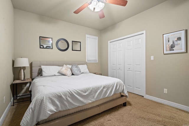 carpeted bedroom with ceiling fan and a closet