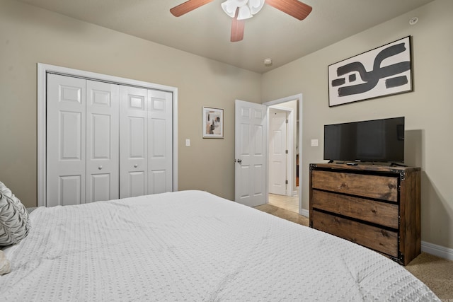 bedroom featuring light carpet, a closet, and ceiling fan