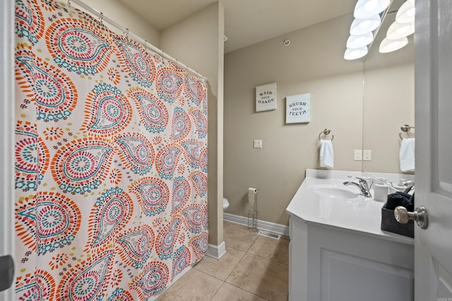 bathroom featuring toilet, a shower with curtain, vanity, and tile patterned floors