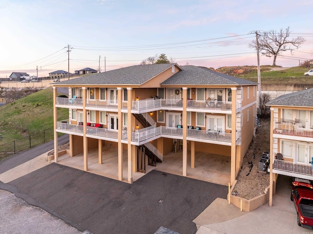 back house at dusk with a balcony