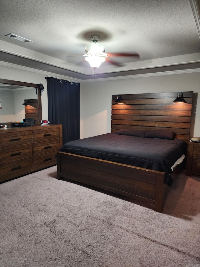 bedroom with ceiling fan, carpet, and a textured ceiling