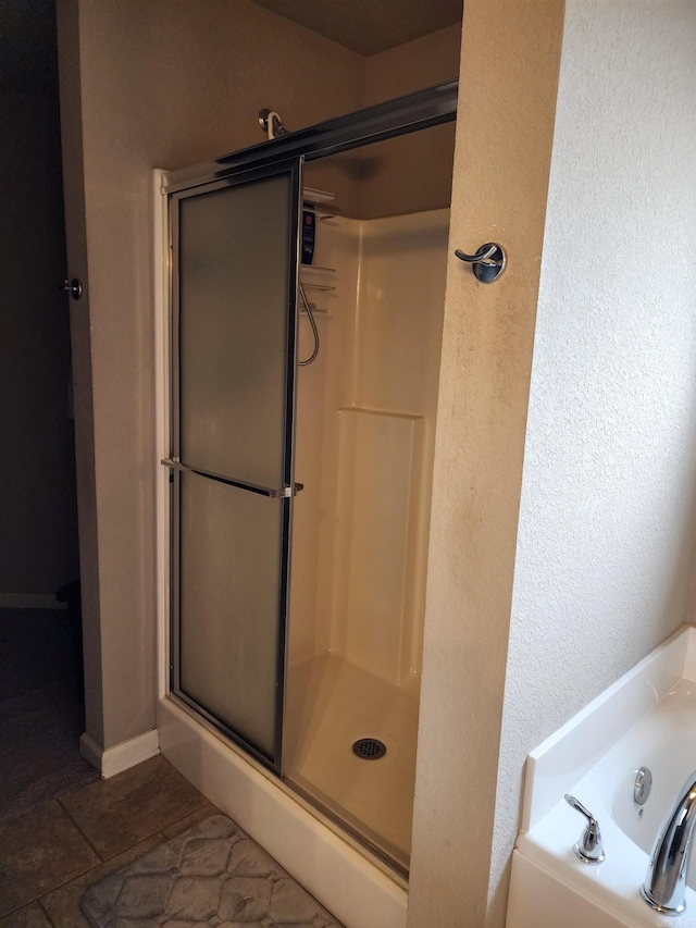 bathroom with tile patterned flooring and separate shower and tub