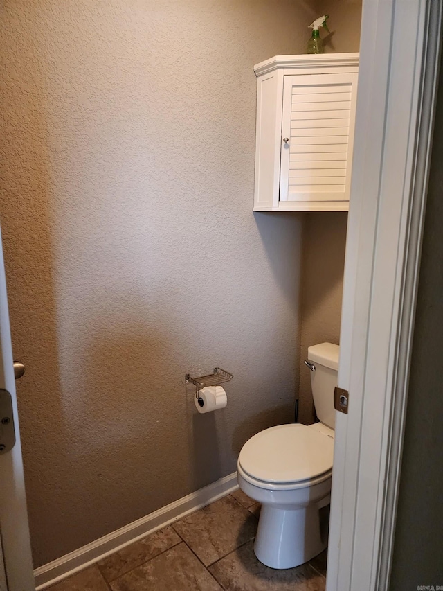 bathroom featuring tile patterned flooring and toilet