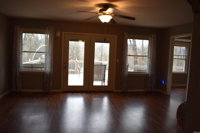 doorway featuring dark hardwood / wood-style flooring, ceiling fan, and plenty of natural light