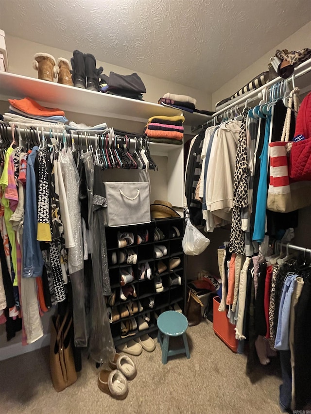 walk in closet with carpet