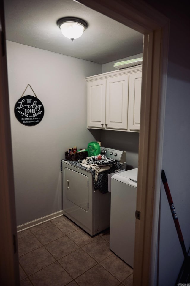 laundry room with tile patterned floors, cabinets, and independent washer and dryer