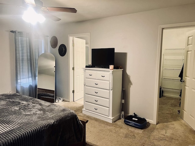 bedroom featuring ceiling fan and light carpet