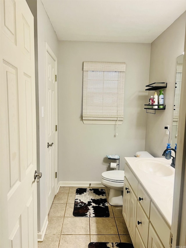 bathroom featuring toilet, vanity, and tile patterned floors