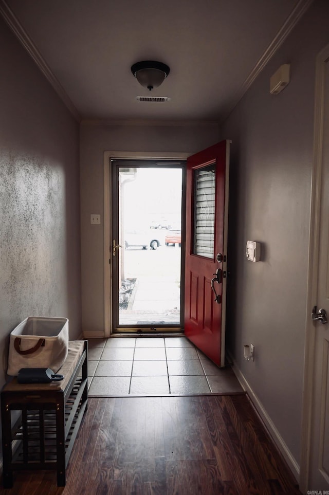 entryway with hardwood / wood-style flooring and ornamental molding