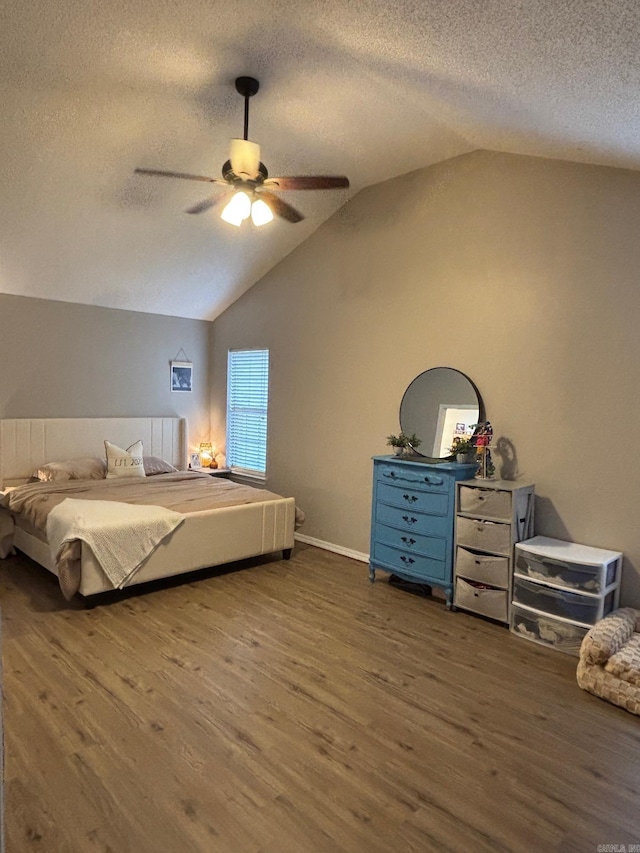 bedroom featuring a textured ceiling, ceiling fan, dark wood-type flooring, and vaulted ceiling