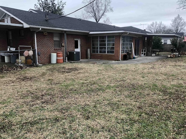 back of house with a lawn and central AC unit