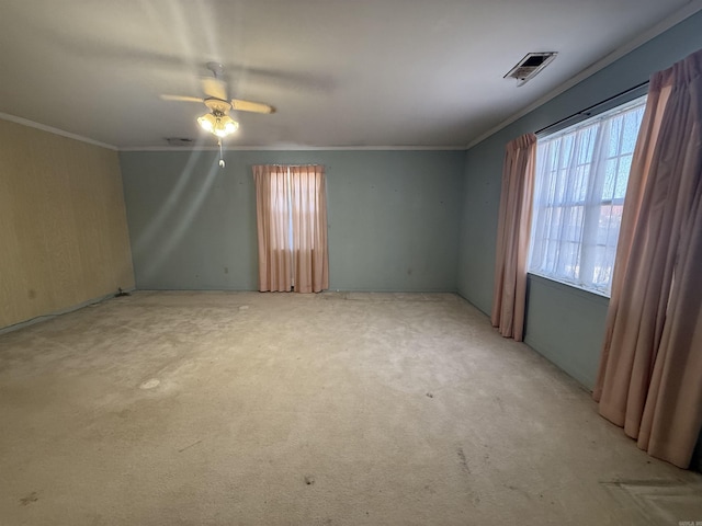 empty room featuring ornamental molding, visible vents, and a healthy amount of sunlight