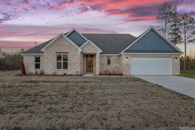 craftsman-style house featuring a yard and a garage