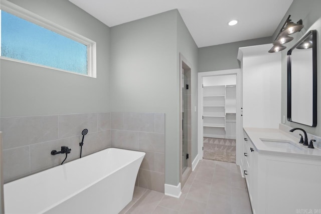 bathroom featuring separate shower and tub, tile patterned flooring, and vanity