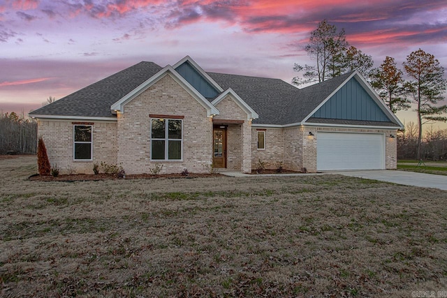 view of front facade with a garage and a yard