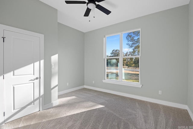 spare room with carpet flooring and ceiling fan