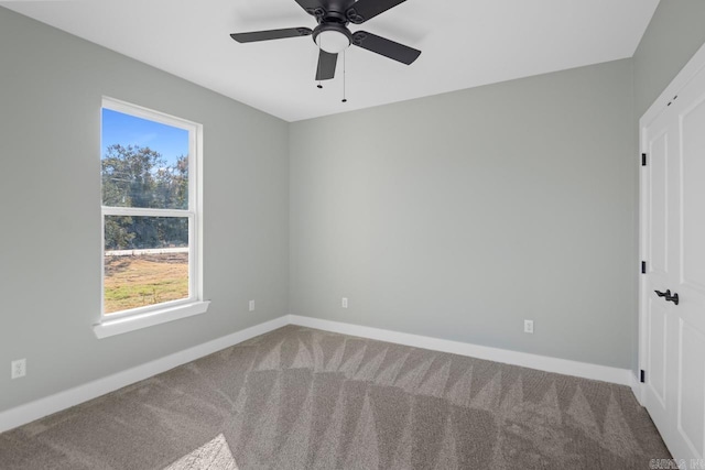 empty room featuring carpet floors and ceiling fan