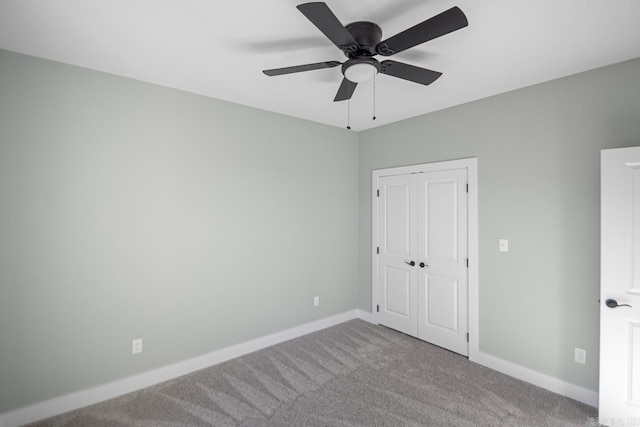 unfurnished bedroom with carpet, a closet, and ceiling fan