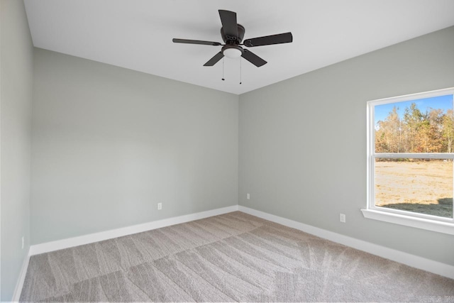 carpeted empty room featuring ceiling fan