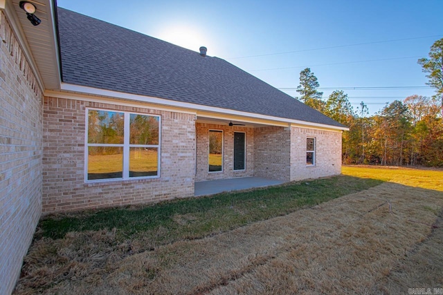 view of home's exterior featuring a patio area and a yard