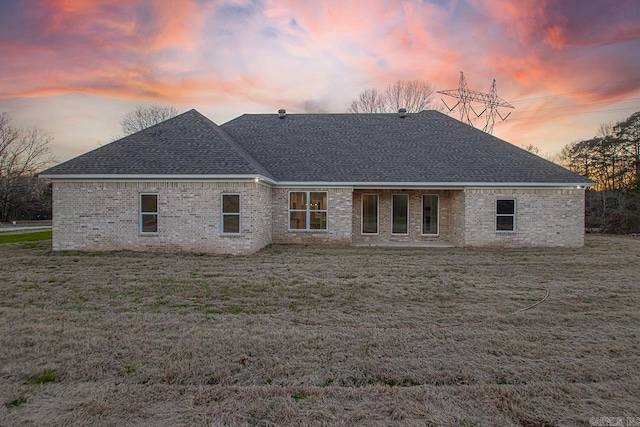 view of back house at dusk