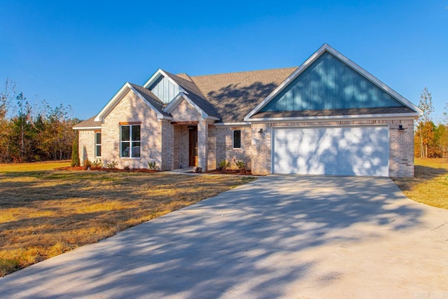 view of front of house with a garage and a front lawn