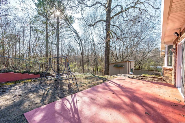 exterior space with a shed and a patio area