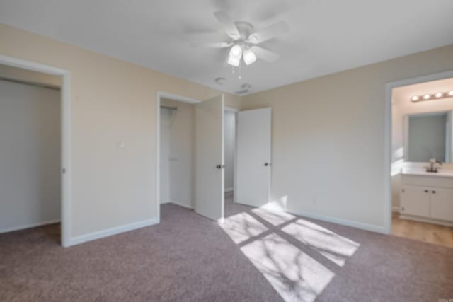 unfurnished bedroom with ensuite bathroom, ceiling fan, light carpet, and a closet