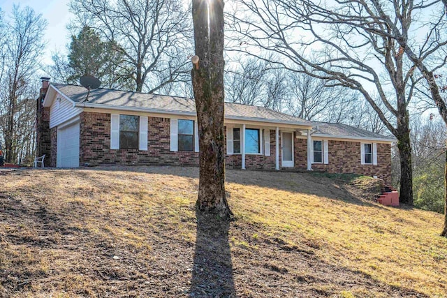 single story home with a garage and a front lawn