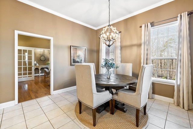 tiled dining space featuring crown molding and a notable chandelier