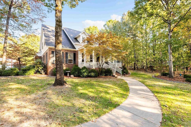 view of front of house with covered porch and a front yard