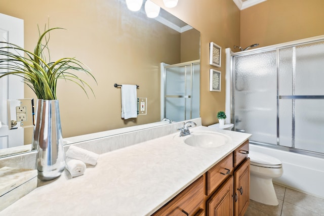 full bathroom featuring tile patterned flooring, toilet, shower / bath combination with glass door, vanity, and ornamental molding