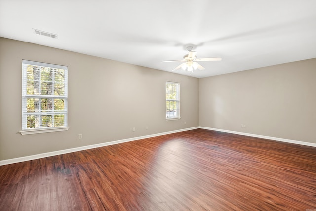 unfurnished room featuring dark hardwood / wood-style floors and ceiling fan