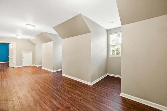 bonus room featuring dark hardwood / wood-style floors and lofted ceiling