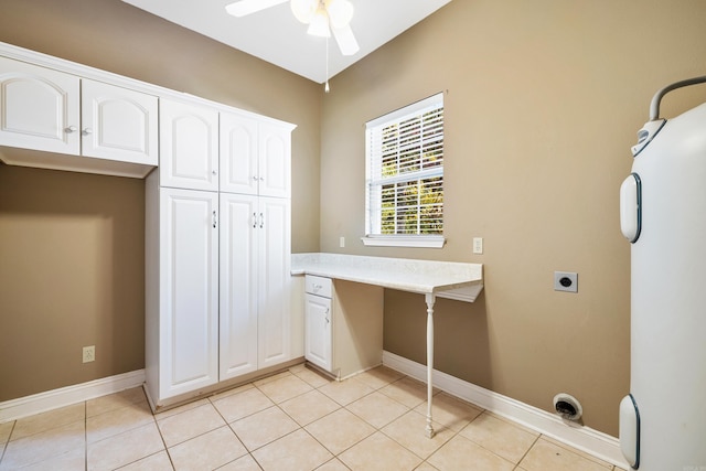 washroom featuring water heater, ceiling fan, light tile patterned flooring, and hookup for an electric dryer