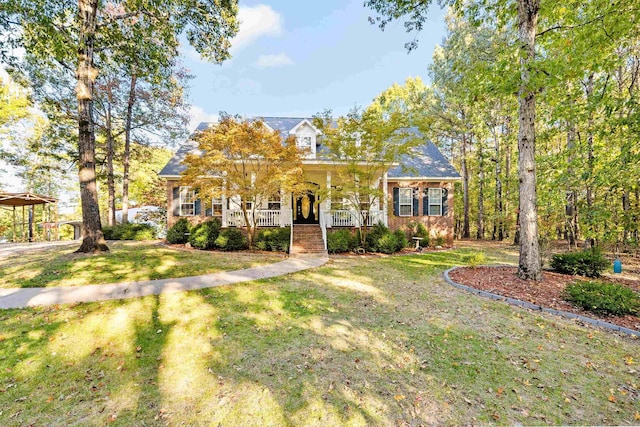 new england style home with covered porch and a front lawn