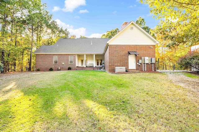 rear view of property featuring a yard