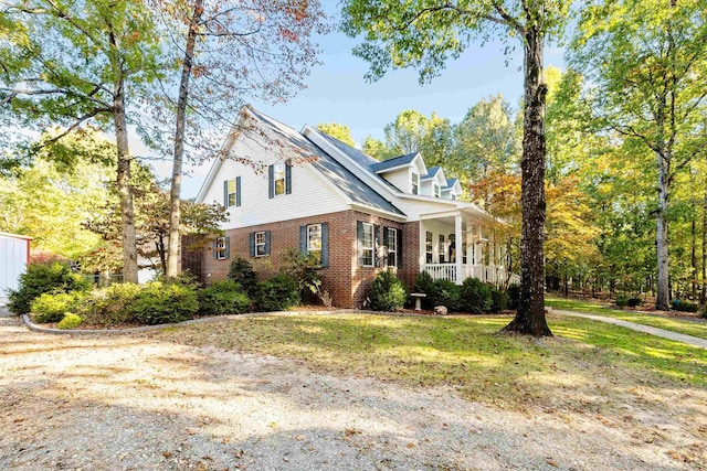 view of front of property with covered porch and a front lawn