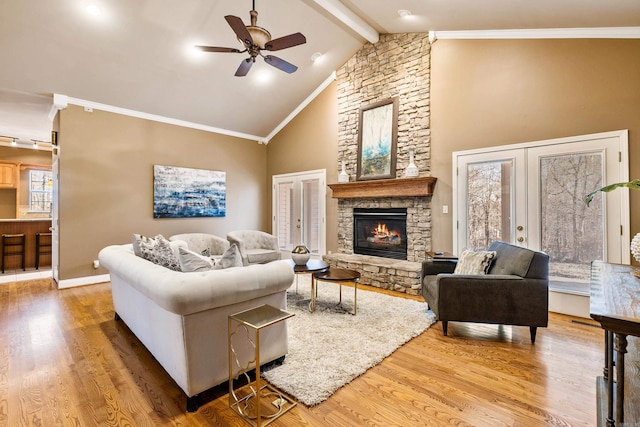 living room with french doors, ceiling fan, beam ceiling, a fireplace, and hardwood / wood-style floors