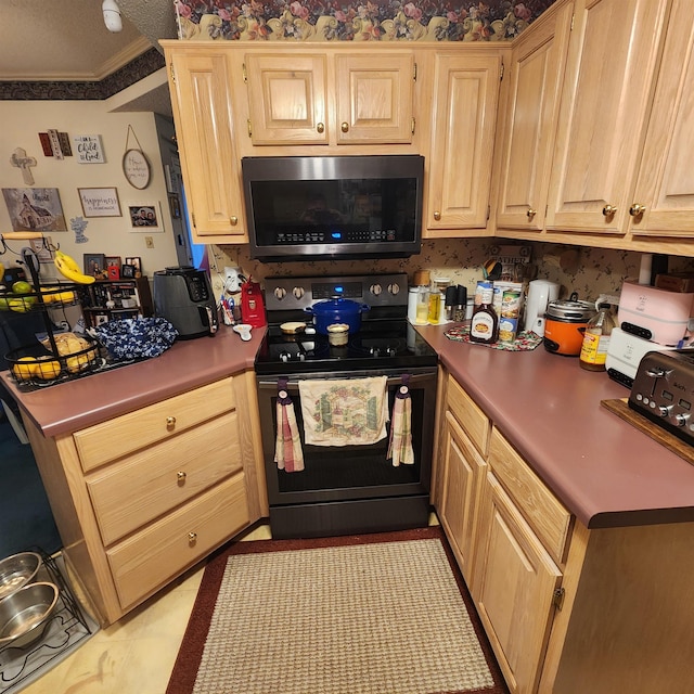 kitchen with light tile patterned flooring, ornamental molding, stainless steel appliances, and light brown cabinetry