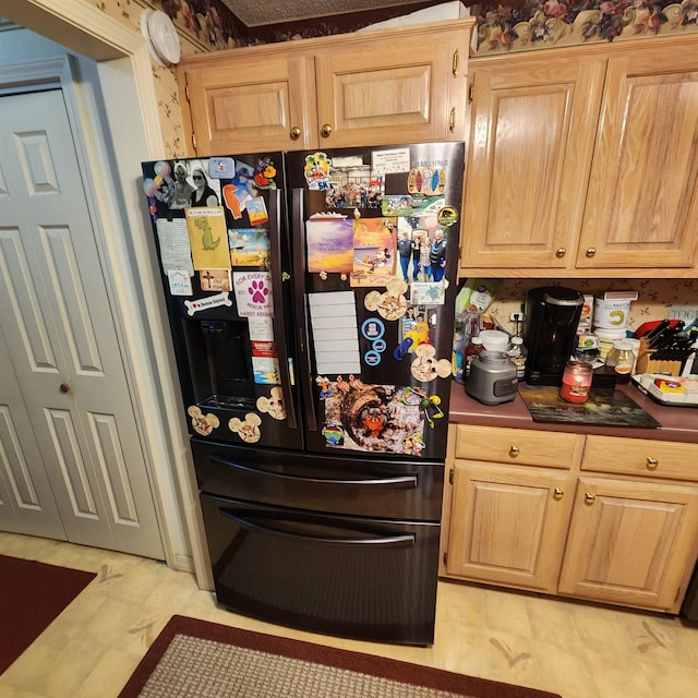 kitchen with black fridge with ice dispenser