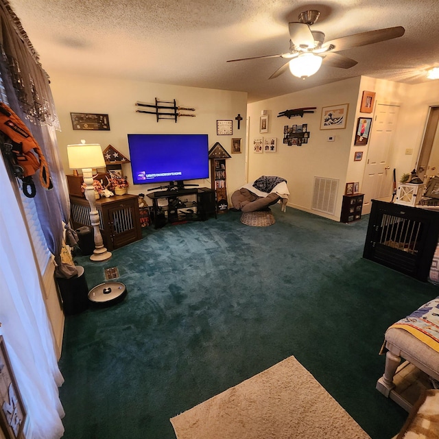 living room featuring carpet flooring, ceiling fan, and a textured ceiling